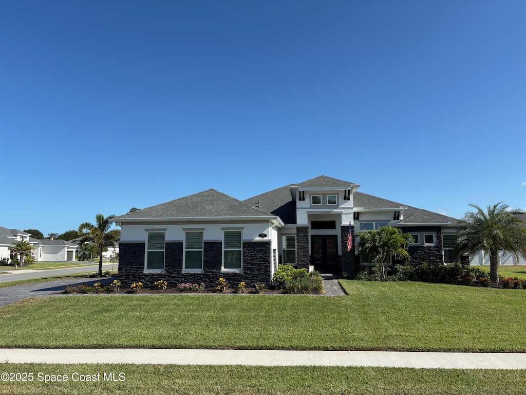 1250 Aranceto Cir, Merritt Island, FL 32952 - prairie-style home with stone siding, a front yard, and stucco siding