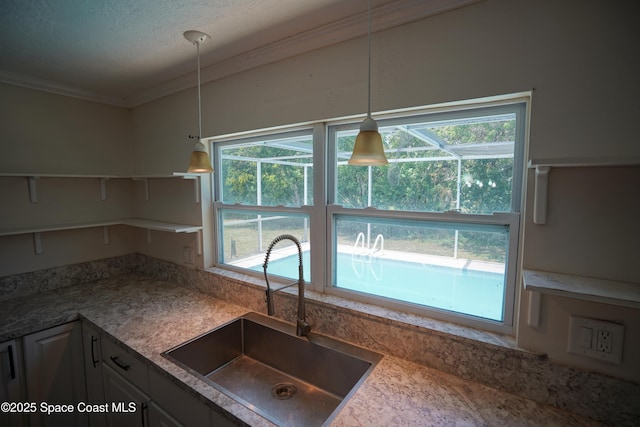 614 W Ct, Titusville, FL 32796 - kitchen with open shelves, ornamental molding, pendant lighting, plenty of natural light, and a textured ceiling