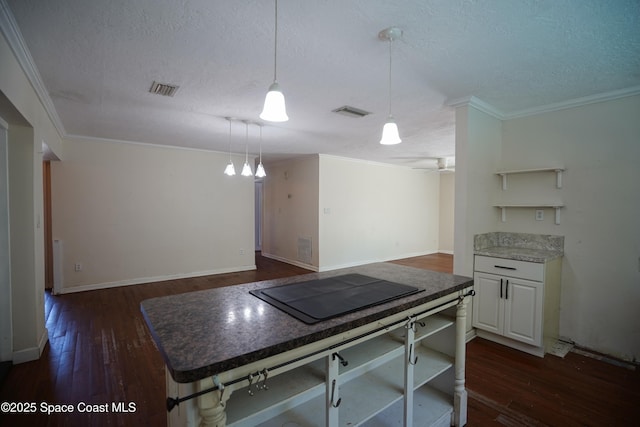 614 W Ct, Titusville, FL 32796 - kitchen with open shelves, a textured ceiling, dark wood-style floors, ornamental molding, and hanging light fixtures
