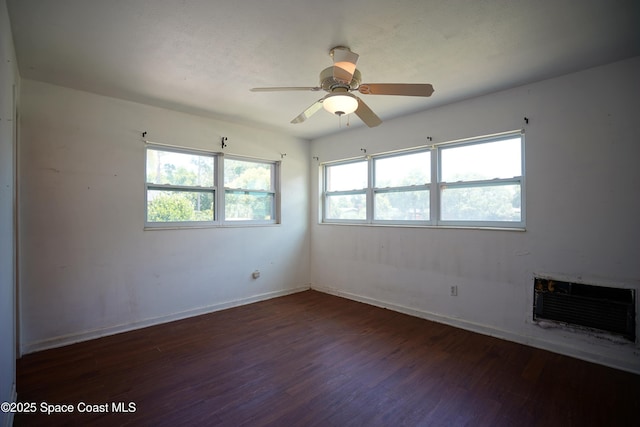 614 W Ct, Titusville, FL 32796 - empty room featuring wood finished floors, ceiling fan, and a wall mounted air conditioner