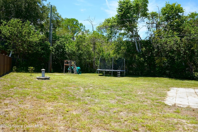 614 W Ct, Titusville, FL 32796 - view of yard with a trampoline and a playground