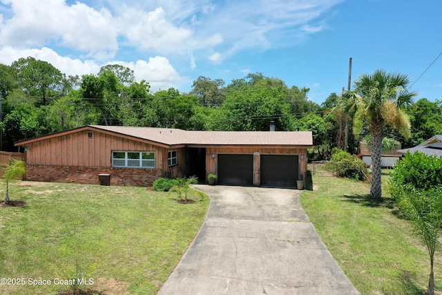 614 W Ct, Titusville, FL 32796 - view of front of home featuring an attached garage, a front lawn, driveway, board and batten siding, and brick siding