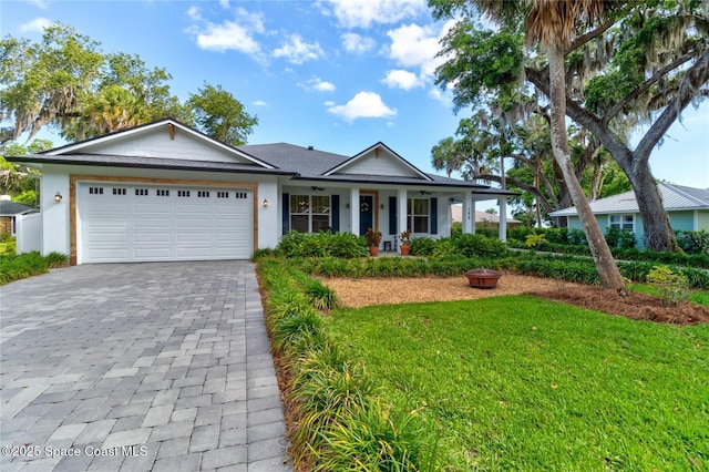 105 Azalea Cir, New Smyrna Beach, FL 32168 - single story home featuring an attached garage, decorative driveway, a front yard, stucco siding, and covered porch