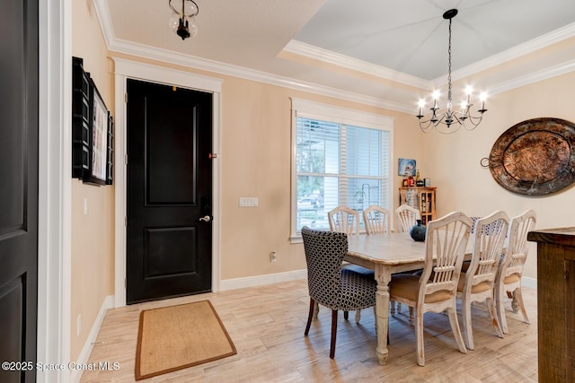 105 Azalea Cir, New Smyrna Beach, FL 32168 - dining space with a chandelier, light wood-style floors, crown molding, and a raised ceiling