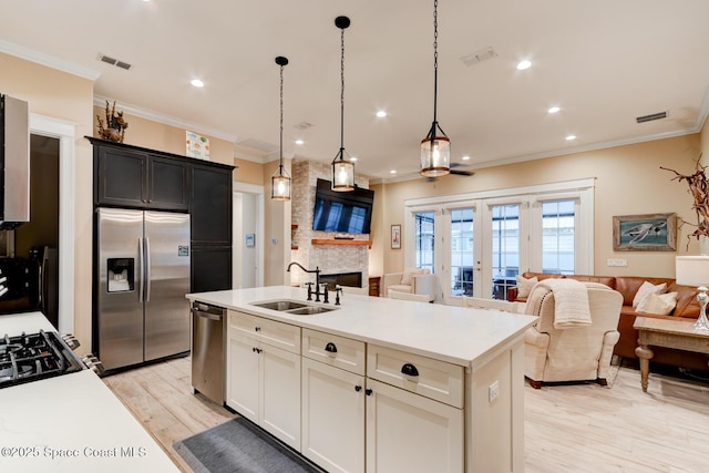 105 Azalea Cir, New Smyrna Beach, FL 32168 - kitchen featuring stainless steel appliances, open floor plan, ornamental molding, light countertops, and light wood-type flooring