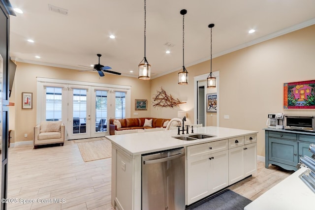 105 Azalea Cir, New Smyrna Beach, FL 32168 - kitchen with stainless steel dishwasher, ornamental molding, white cabinets, light wood finished floors, and ceiling fan