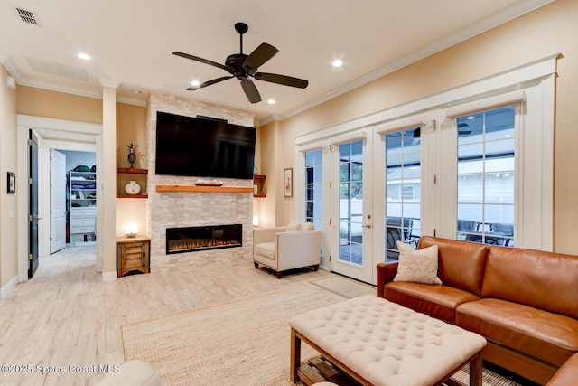 105 Azalea Cir, New Smyrna Beach, FL 32168 - living area with ornamental molding, light wood-style flooring, ceiling fan, a fireplace, and french doors