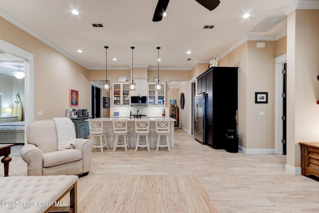 105 Azalea Cir, New Smyrna Beach, FL 32168 - living room featuring a ceiling fan, recessed lighting, light wood-type flooring, and crown molding