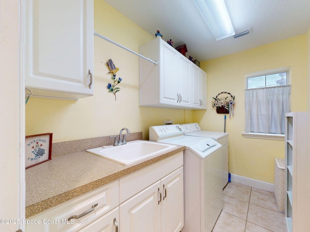 6025 Brabrook Ave, Grant, FL 32949 - laundry area with washing machine and clothes dryer, cabinet space, and light tile patterned floors
