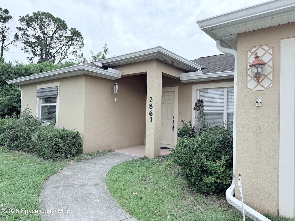 2861 Emerson Dr SE, Palm Bay, FL 32909 - property entrance featuring stucco siding