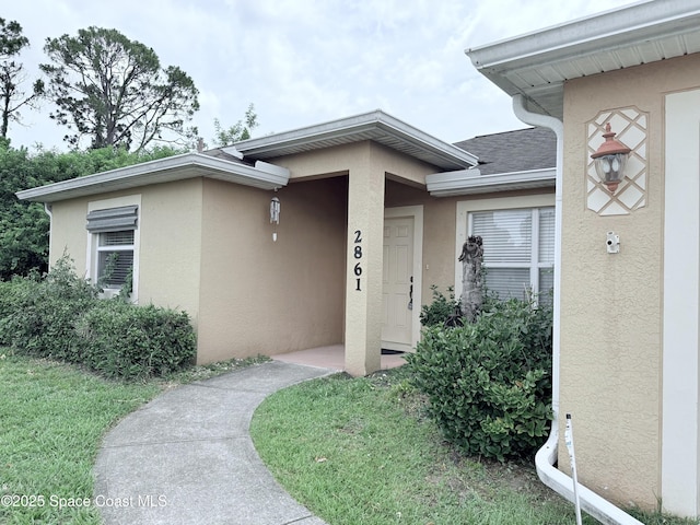 2861 Emerson Dr SE, Palm Bay, FL 32909 - property entrance featuring stucco siding