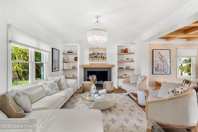 2600 N Riverside Dr, Indialantic, FL 32903 - living area featuring a chandelier, wood finished floors, crown molding, a fireplace, and beam ceiling