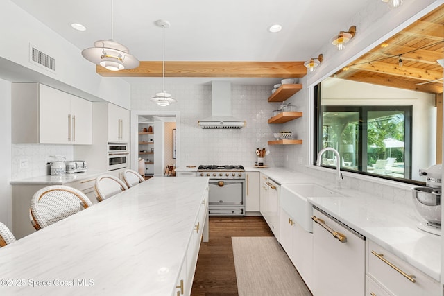 2600 N Riverside Dr, Indialantic, FL 32903 - kitchen featuring wall chimney range hood, white appliances, tasteful backsplash, white cabinets, and light stone countertops