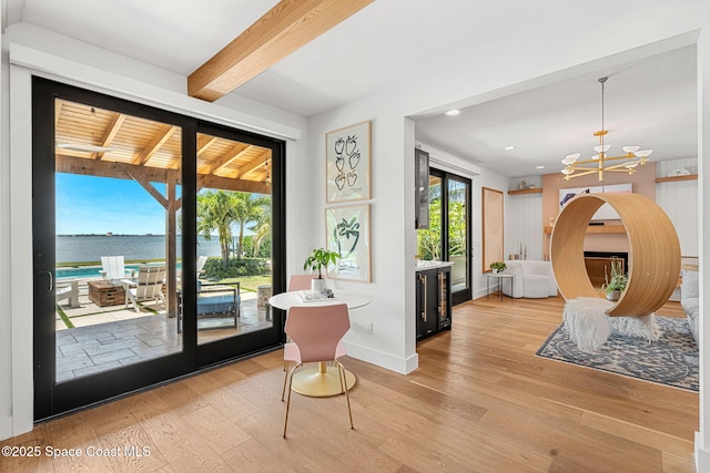 2600 N Riverside Dr, Indialantic, FL 32903 - entrance foyer with light wood-style floors, a chandelier, a water view, beamed ceiling, and recessed lighting
