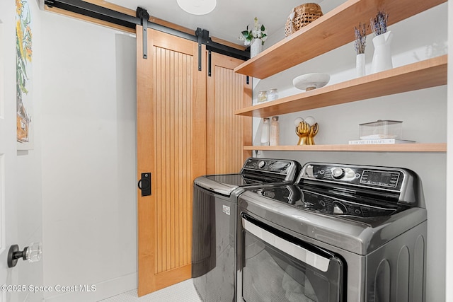 2600 N Riverside Dr, Indialantic, FL 32903 - laundry area featuring a barn door and washer and dryer