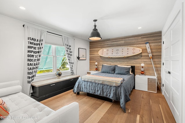 2600 N Riverside Dr, Indialantic, FL 32903 - bedroom featuring light wood-style floors, recessed lighting, and log walls