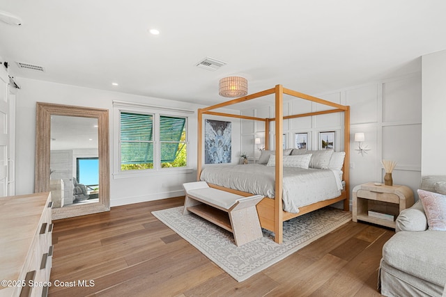 2600 N Riverside Dr, Indialantic, FL 32903 - bedroom featuring wood finished floors, a decorative wall, and recessed lighting