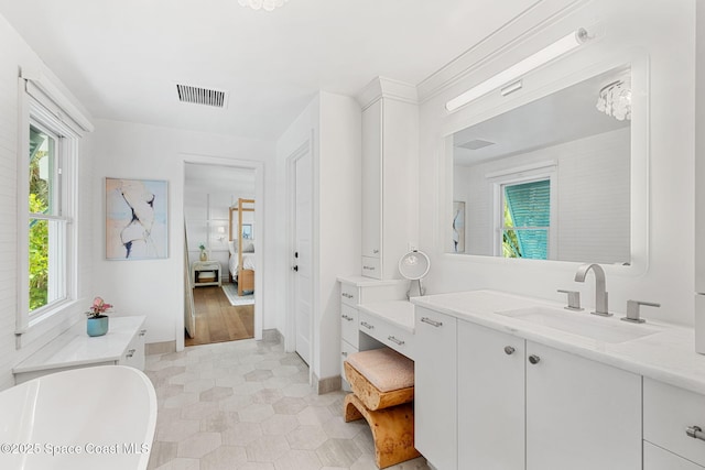 2600 N Riverside Dr, Indialantic, FL 32903 - ensuite bathroom with vanity, plenty of natural light, a bathtub, and tile patterned floors