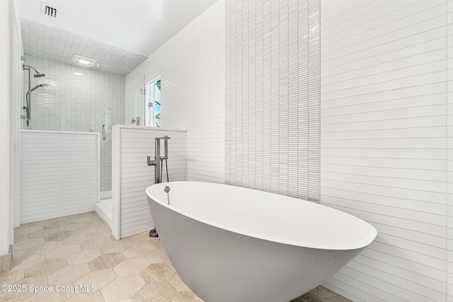 2600 N Riverside Dr, Indialantic, FL 32903 - full bathroom with a shower stall, tile walls, and a soaking tub