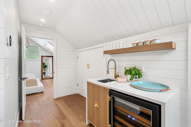 2600 N Riverside Dr, Indialantic, FL 32903 - bar featuring beverage cooler, light wood finished floors, lofted ceiling, and wood walls