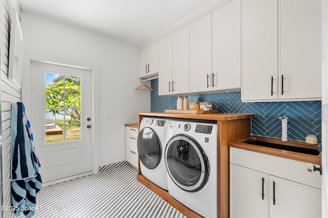 2600 N Riverside Dr, Indialantic, FL 32903 - laundry area with cabinet space and washer and clothes dryer