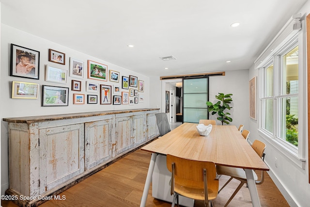 2600 N Riverside Dr, Indialantic, FL 32903 - dining space featuring light wood-type flooring, recessed lighting, and a barn door
