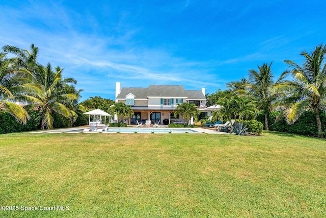2600 N Riverside Dr, Indialantic, FL 32903 - back of house featuring an outdoor pool, a lawn, a patio, and a gazebo