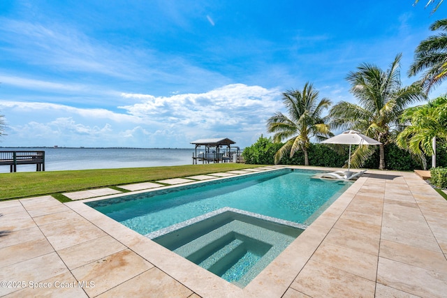 2600 N Riverside Dr, Indialantic, FL 32903 - view of pool featuring a lawn, a water view, a pool with connected hot tub, and a patio