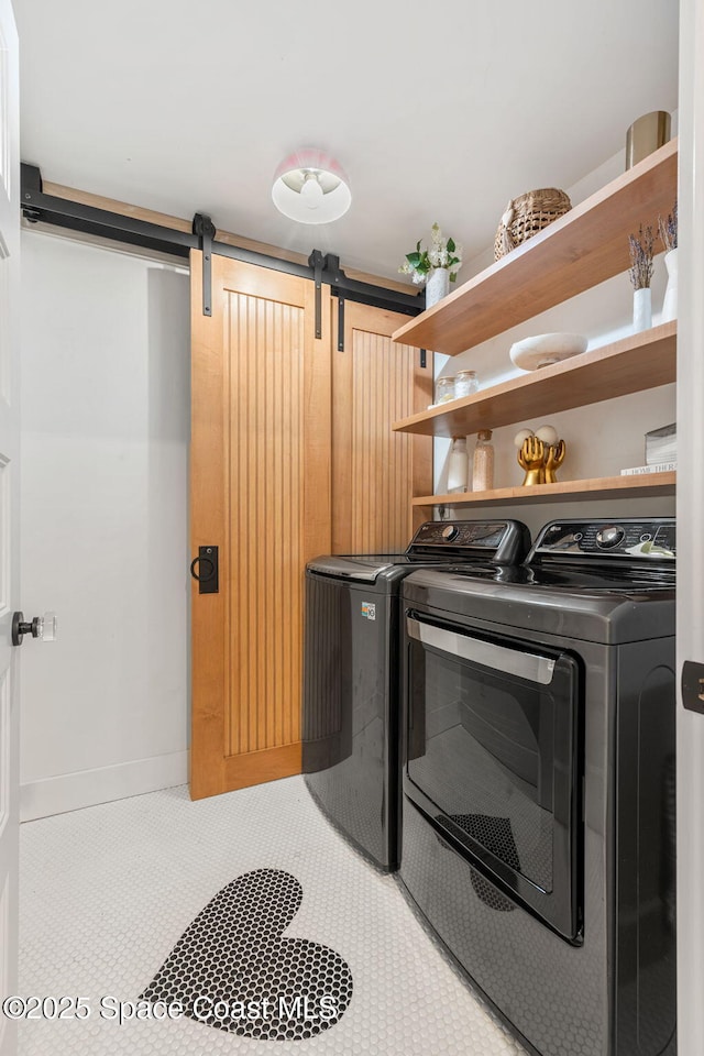 2600 N Riverside Dr, Indialantic, FL 32903 - laundry area featuring a barn door and washer and clothes dryer