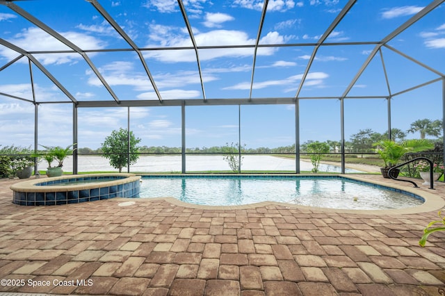 7873 Desmond Ave, Melbourne, FL 32940 - view of pool with a patio area, glass enclosure, a pool with connected hot tub, and a water view