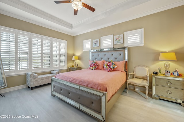 7873 Desmond Ave, Melbourne, FL 32940 - bedroom featuring light wood-type flooring, ornamental molding, a tray ceiling, and ceiling fan