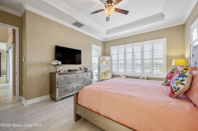7873 Desmond Ave, Melbourne, FL 32940 - bedroom with light wood-style flooring, ornamental molding, a raised ceiling, and ceiling fan