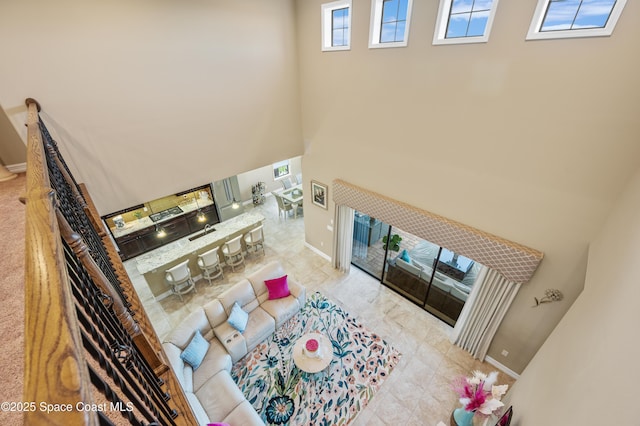 7873 Desmond Ave, Melbourne, FL 32940 - living area featuring a towering ceiling and baseboards
