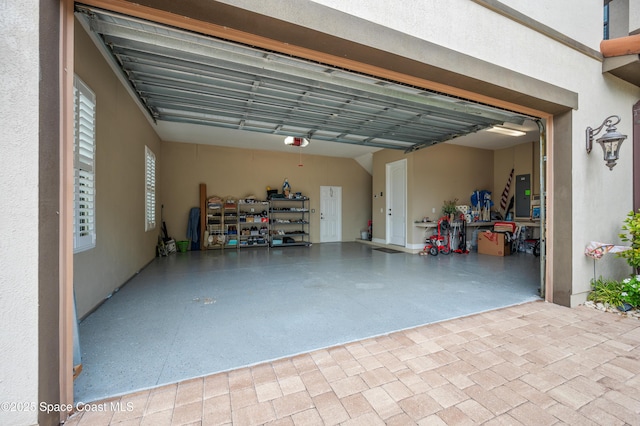 7873 Desmond Ave, Melbourne, FL 32940 - garage with a garage door opener, driveway, and electric panel