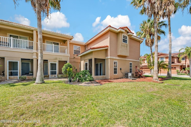 1375 Isabella Dr Unit 108, Melbourne, FL 32935 - rear view of house featuring stucco siding and a yard