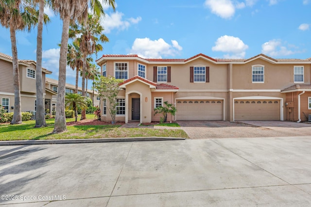 1375 Isabella Dr Unit 108, Melbourne, FL 32935 - view of front of home featuring a tile roof, stucco siding, a garage, and driveway