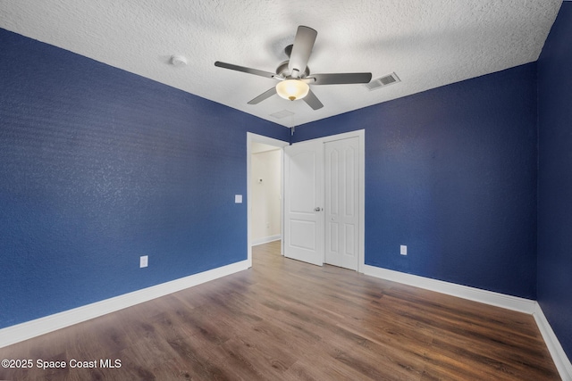 1375 Isabella Dr Unit 108, Melbourne, FL 32935 - unfurnished bedroom featuring wood finished floors, a textured ceiling, ceiling fan, and a closet