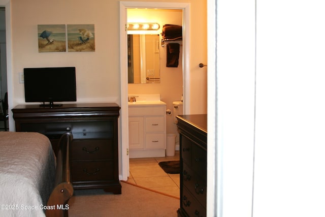 201 Saint Lucie Ln Unit 309, Cocoa Beach, FL 32931 - bedroom with connected bathroom and a sink