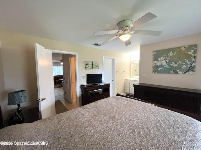 201 Saint Lucie Ln Unit 309, Cocoa Beach, FL 32931 - bedroom with a ceiling fan and ensuite bath