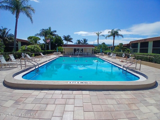 201 Saint Lucie Ln Unit 309, Cocoa Beach, FL 32931 - community pool featuring a patio