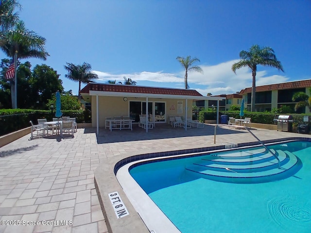 201 Saint Lucie Ln Unit 309, Cocoa Beach, FL 32931 - community pool with a patio and outdoor dining area