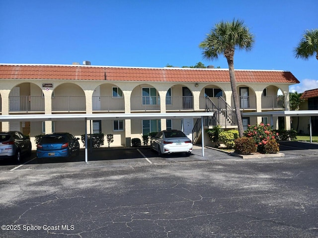 201 Saint Lucie Ln Unit 309, Cocoa Beach, FL 32931 - view of building exterior with covered parking