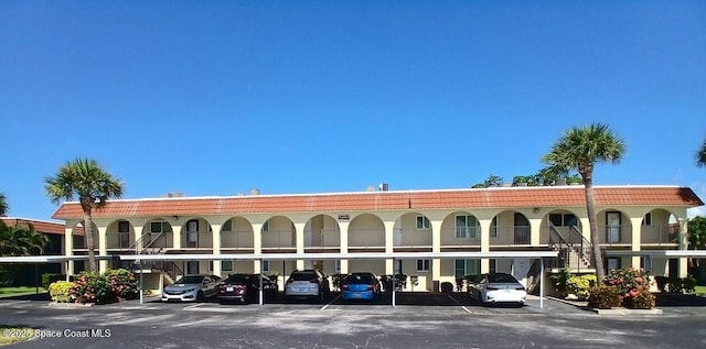 201 Saint Lucie Ln Unit 309, Cocoa Beach, FL 32931 - view of building exterior with covered parking