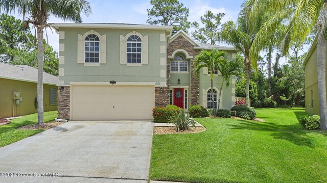 4060 Aria Dr, Melbourne, FL 32904 - view of front of property with stone siding, driveway, stucco siding, an attached garage, and a front lawn