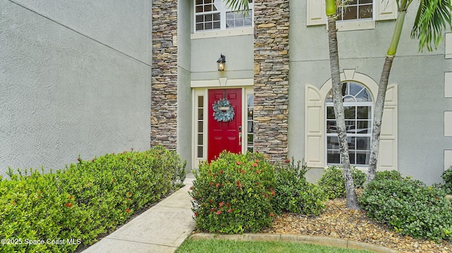 4060 Aria Dr, Melbourne, FL 32904 - view of exterior entry featuring stone siding and stucco siding