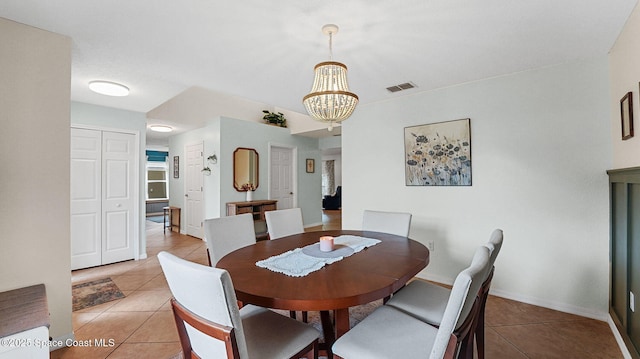 4060 Aria Dr, Melbourne, FL 32904 - dining area with light tile patterned floors and a chandelier