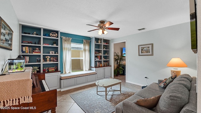 4060 Aria Dr, Melbourne, FL 32904 - living room featuring ceiling fan, light tile patterned floors, and a textured ceiling