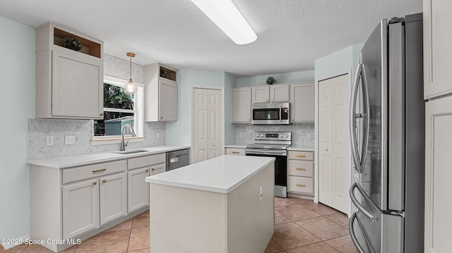 4060 Aria Dr, Melbourne, FL 32904 - kitchen with stainless steel appliances, tasteful backsplash, a center island, light countertops, and a textured ceiling