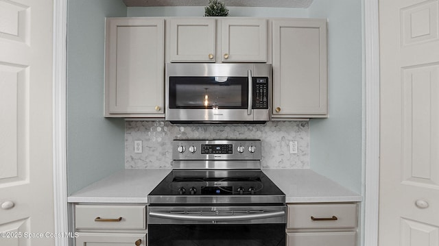 4060 Aria Dr, Melbourne, FL 32904 - kitchen with stainless steel appliances, tasteful backsplash, and light countertops
