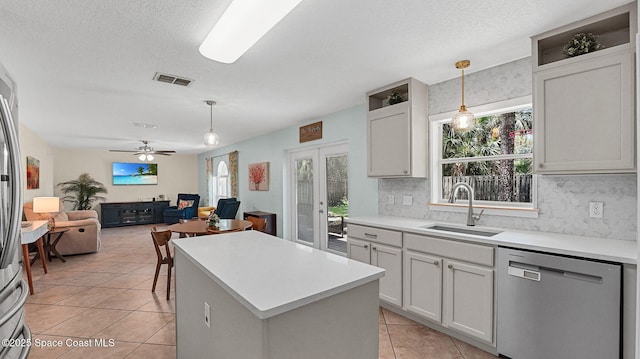 4060 Aria Dr, Melbourne, FL 32904 - kitchen with appliances with stainless steel finishes, light tile patterned flooring, french doors, hanging light fixtures, and light countertops